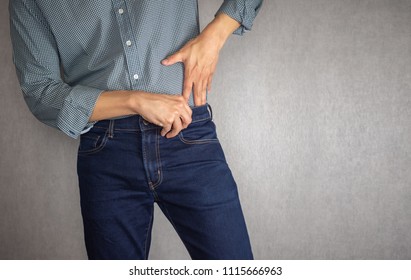 Tuck shirt into jeans close up - Shutterstock ID 1115666963