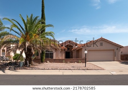 Tucson Arizona home with palm tree in front yard. 