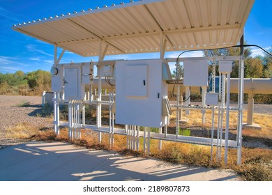 Tucson, Arizona- Sweetwater Wetlands Electric Water Treatment Utility Infrastructure. Electronic Water Treatment Under A Roof Against The Wild Trees And Plants At The Back.