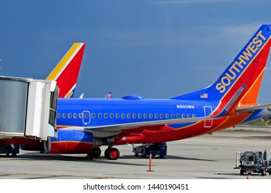 Tucson, Ariz./USA-6/30/19: Southwest Airlines 737 aircraft parked at the gates, their profiles standing out against a sky darkened by approaching summer monsoons.                                