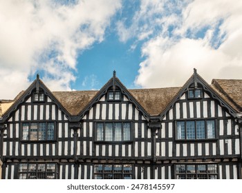 Tudor architecture. Upper part of black and white half-timbered houses in a row in Shakespeare's hometown Stratford-upon-Avon, UK. Picturesque English Jacobean or Elizabethan style from 16th century.  - Powered by Shutterstock