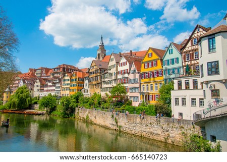Tuebingen in the Stuttgart city ,Germany
Colorful house in riverside and blue sky. Beautiful old city in Europe.People sitting on the wall.Boats wooden moored at dock.