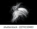 Tuft of white fur, heap gray-haired animal hair isolated on black, top view