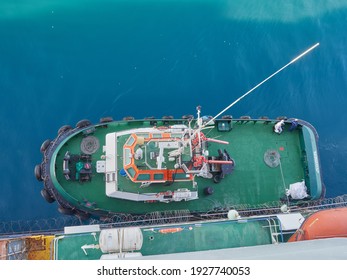 Tug Boat Approaching To The Container Vessel For Mooring Near The Port. View From Above.