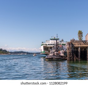 a tug boat in front of a huge ferry in the bay in Olympia Washington on July 3rd 2018  