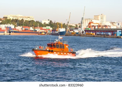 Tug Boat In Front Of Sea Port