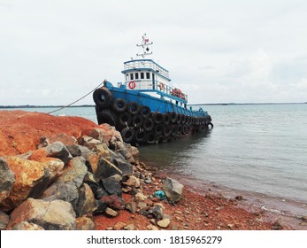 A Tug Boat Was Leaning Back Waiting For The Crew To Return From Land