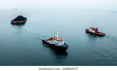 Tug boat pulling barge coal sea assisting - Shutterstock ID 2268966377