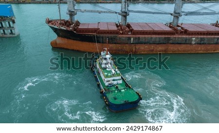 Tug boat pulling cargo container ship to dry dock concept maintenance service working in the sea. Insurance and Maintenance Cargo Ship concept. Freight Forwarding Service maintenance Insurance