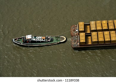 tug boat pulling refuse containers on the thames