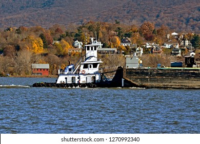 Tug Boat Pushing A Barge Of Cargo Down The Hudson River