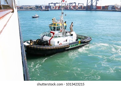 Tug Boat Pushing A Ship In The Port Of San Antonio, Chile