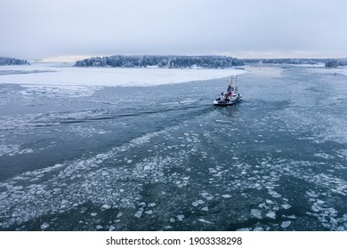 Tug Boat Pushing Through The Ice On A Sea In Winter