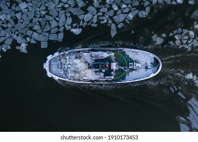 Tug Boat Pushing Through The Ice On A Sea In Winter