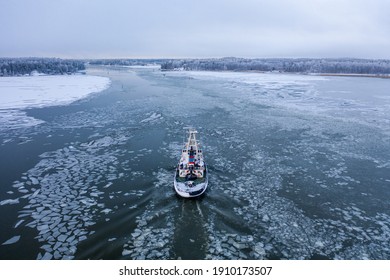 Tug Boat Pushing Through The Ice On A Sea In Winter