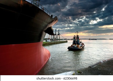 Tug Boat Taking Out The Ship From The Harbor