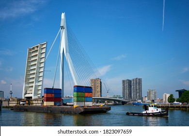 Tug Boat Towing Barge With Containers Under Open Bascule Part Of Erasmusbrug Bridge In Nieuwe Maas River. Rotterdam, Netherlands