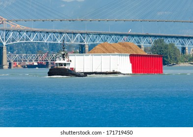 A Tug Boat Towing Barge Loaded With Cargo. Vancouver, Canada.