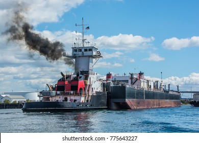 Tug Inserted In Notch In Stern Of Barge.