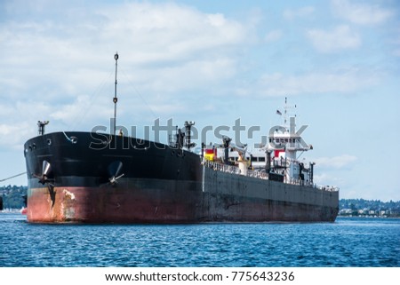 Tug inserted in notch in stern of barge.