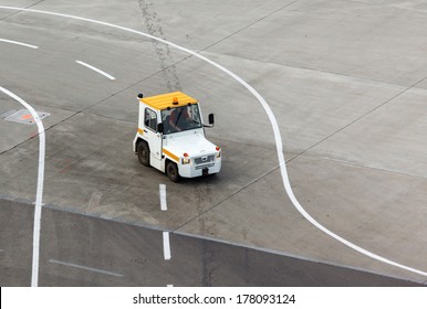 Tug And Luggage On The Airport Tarmac