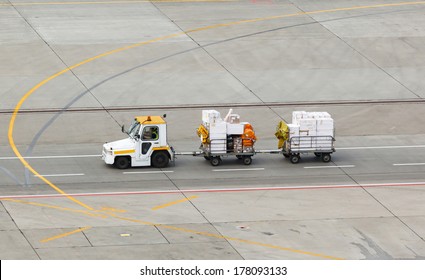 Tug And Luggage On The Airport Tarmac