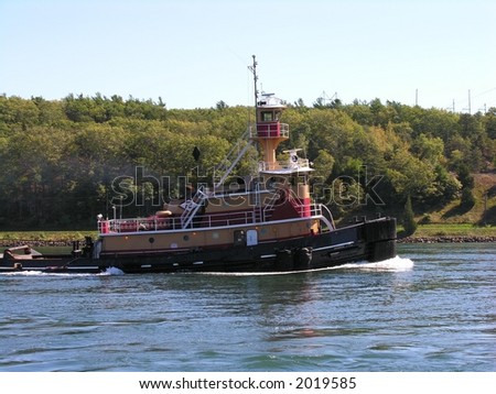 Tug pulling a fuel barge