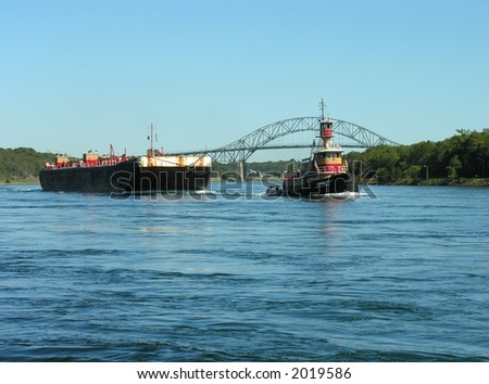 Tug pulling a fuel barge thru the Cape Cod Canal.