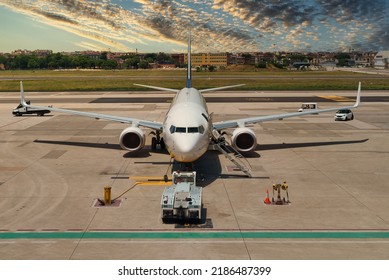 TUG Pushback Tractor With Aircraft On The Runway In Airport.