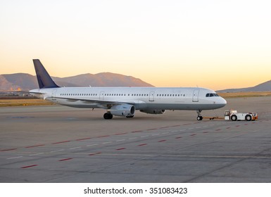 TUG Pushback tractor with Aircraft on the runway in airport. - Powered by Shutterstock