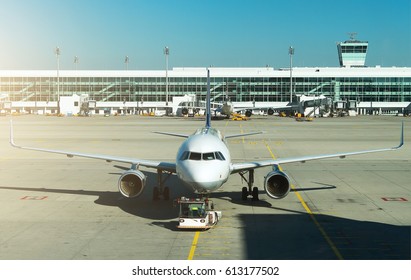 TUG Pushback Tractor With Aircraft On The Runway In Airport.