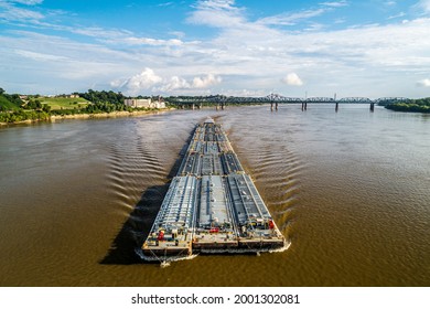 Tug pushing barges upstream on the Mississippi River near Vicksburg, MS