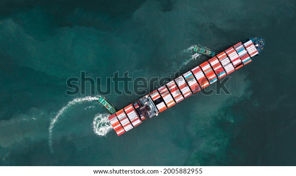 tug ship\
drag container cargo smart ship vessel to cargo international\
container yard port concept shipping by\
sea.