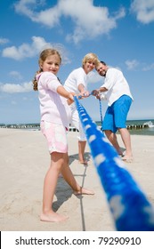 Tug Of War - Family Playing On The Beach