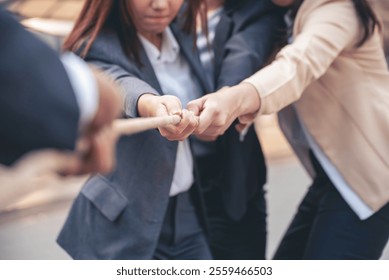 Tug of war Group of business people Hands pulling rope symbol team unified teamwork Partnership Concept. Businesswoman Team holding hands together partnership leader teamwork. diversity competition - Powered by Shutterstock