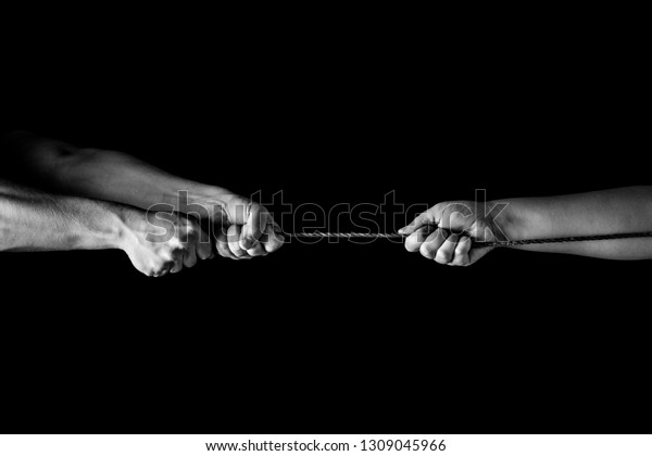 Tug war, man and woman pulling rope in\
opposite directions unequally, uneven. copy\
space