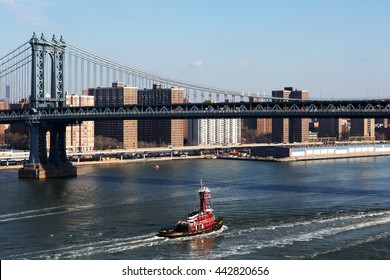 A Tugboat On The East River Under The Manhattan Bridge.