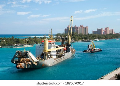 The Tugboat Pulling An Industrial Ship In Nassau Harbour Along Paradise Island (Bahamas).