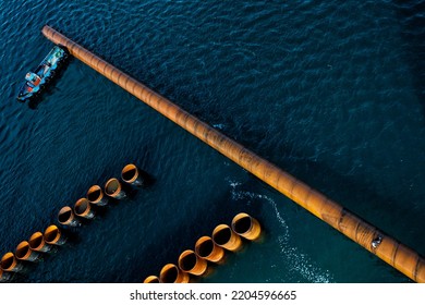 Tugboat Pushing The Steel Pile For Pile Driving 