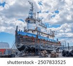 Tugboat Restoration:  An old tugboat receives much needed repairs at a New England shipyard.
