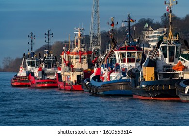 Tugboats In The Harbour Of Hamburg Germany Waiting For Big Ships To Be Helped And Pulled, Fire Fighter Boat, Pilots And Navigator Guide For Captains