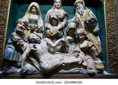 Tui, Spain; 6.27.2021: Sculptural group in polychrome wood with the scene of the descent from the cross with the dead Christ
selective focus