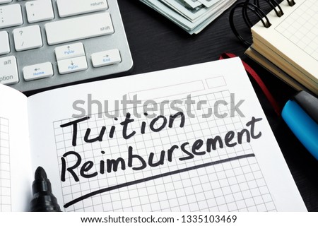 Tuition reimbursement written on a page of notepad.