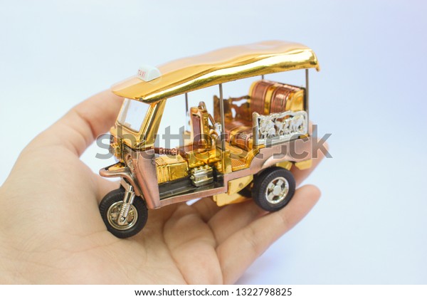 Tuk Tuk -  Thailand taxi model, mini toy on\
isolated white background