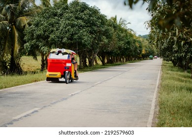 Tuktuk taxi scooter on the tropical road.