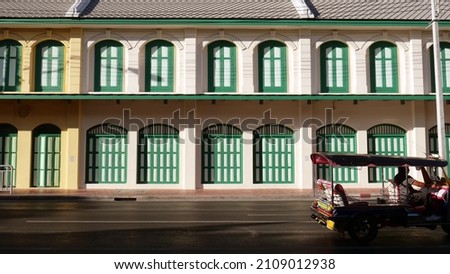 Tuk-Tuk, Thailand's signature tricycle, is passing in front of the MRT station (subway). Sam Yod station is located in the old town, so the building has been well preserved. Sam Yot. shop house.   