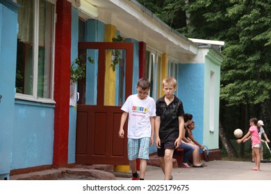 Tula, Tula region, Russia-25.05.2014: Two boys about nine years old are walking down the street. A sad guy dressed in a black T-shirt and black shorts. The boy bowed his head down. Friends communicate