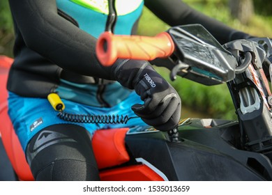 Tula/Russia - AUGUST 12, 2019 Man's Hand Holds A Jet Ski Ignition Key.