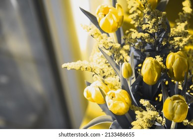 Tulip Flowers Bouquet On Table Near Window. Moody Background. Vintage Grey Yellow Toned Photo. Selective Focus And Shallow Depth Of Field.