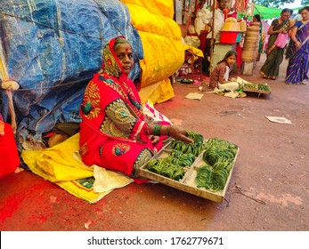 Tuljapur, India- December 19th 2019; Stock Photo Of 50 To 60 Age Group Indian Women Wearing Red Color Saree, Selling Green Color Traditional Glass Bangles In The Street Market At Tuljapur, Maharashtra